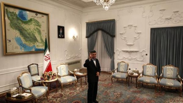 Iranian President Mahmoud Ahmadinejad flashes a victory sign ahead of his meeting with Syrian Prime Minister Wael al-Halaqi in Tehran. (AFP PHOTO/BEHROUZ MEHRI)