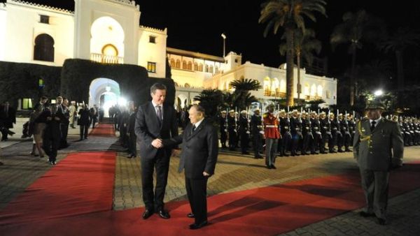 Algeria's President Abdelaziz Bouteflika (R) greets British Prime Minister David Cameron upon his arival at the People's Palace in the capital Algiers on Thursday. (AFP PHOTO/ FAROUK BATICHE)