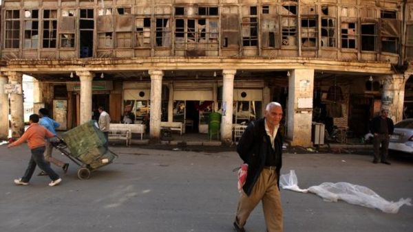Iraqis walk in al-Rasheed street, the oldest street in the Iraqi capital Baghdad. (AFP PHOTO/PATRICK BAZ)