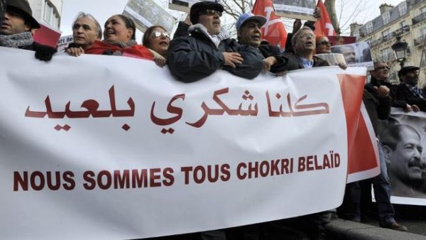 People hold a banner reading "We are all Chokri Belaid" during a protest to pay tribute to murdered opposition figure in Paris. (AFP PHOTO MEHDI FEDOUACH)