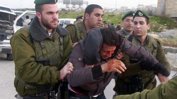 Israeli border policemen arrest a Palestinian man at the entrance of the village of Zayem, as he was on his way to join an "outpost" named Bab al-Shams. (TOPSHOTS/AFP PHOTO/MUSA AL SHAER)