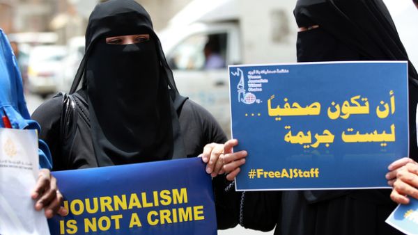 Yemeni women hold placards during a protest on 25 June 2014 in the capital Sanaa in solidarity with Al Jazeera journalists jailed in Egypt at the time. (AFP/File)