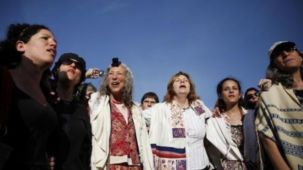 Members of the liberal Jewish religious group Women of the Wall wear phylacteries and the "Tallit" shawl, traditional Jewish prayer apparel for men, as they pray at the Western Wall in Jerusalem's Old City on Friday. AFP Photo