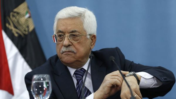 Palestinian Authority President Mahmoud Abbas gestures at his watch. (AFP/File photo)