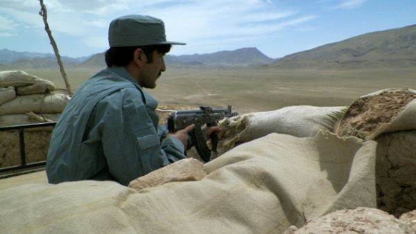 An Afghan policeman observes the Tarin Kot highway in central Afghanistan. (AFP/File) An Afghan policeman observes the Tarin Kot highway in central Afghanistan. (AFP/File)