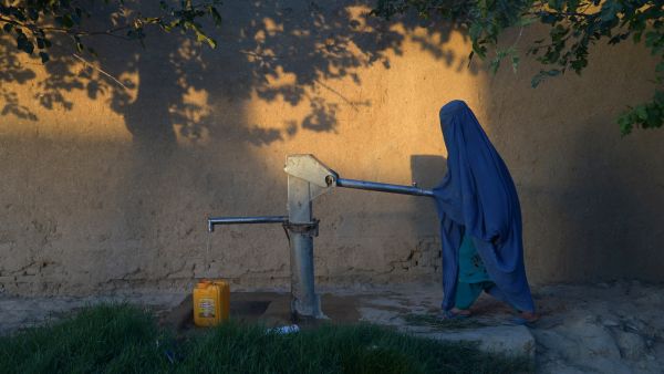 An Afghan woman collects water from pump. (AFP) 