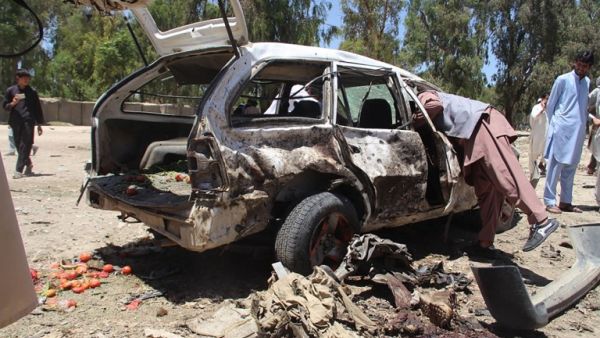 Afghan residents gather at the scene of a suicide car bomb that targeted a CIA-funded pro-government militia force at a public bus station in Khost province on May 27, 2017. (Farid Zahir/AFP)
