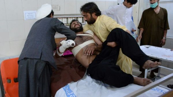 A victim is helped by relatives at a hospital after eight people were killed and 45 wounded in a series of explosions targeting a cricket match in the eastern Afghan city of Jalalabad. (AFP/ File Photo)