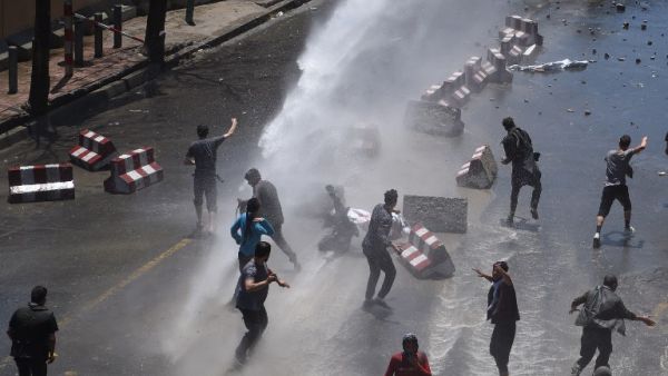 Afghan security forces use water canons to disperse protesters during clashes at a protest against the government following a catastrophic truck bomb attack near Zanbaq Square in Kabul on June 2, 2017. (Wakil Kohsar/AFP)