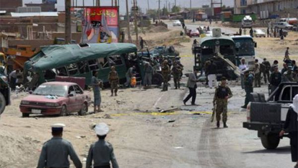 Afghan security personnel gather near the wreckage of buses which were carrying police cadets, at the site of a bomb attack on the outskirts of Kabul on June 30, 2016. (AFP)
