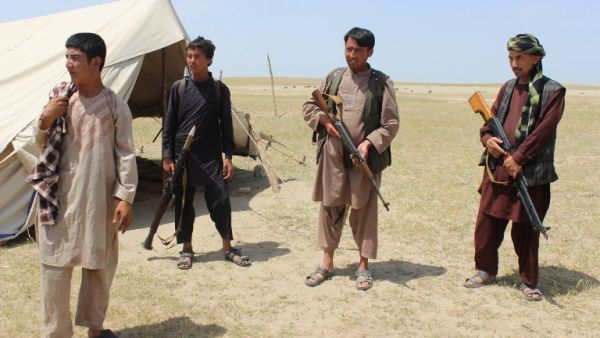 Members of an Afghan militia look on during fighting between Taliban militants and Afghan security forces near the Qala-e-Zal district in Kunduz province on May 7, 2017. (AFP/Bashir Khan Safi)