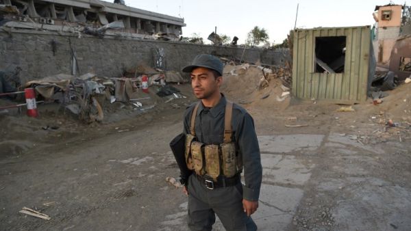 An Afghan policeman stands near the scene of a truck bomb attack in Kabul on May 31, 2017. (AFP/Wakil Kohsar)