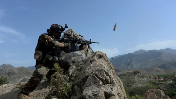 In this photograph taken on April 11, 2017, an Afghan security force personnel fires during an ongoing an operation against Daesh militants in the Achin district of Nangarhar province. (AFP/Noorullah Shirzada)
