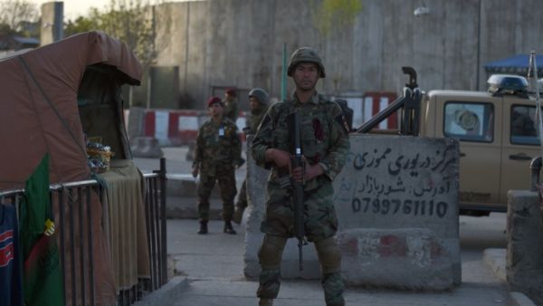 Afghan security personnel stand guard at the site of a suicide attack near the Ministry of Defense in Kabul on April 12, 2017. (AFP/Wakil Kohsar)