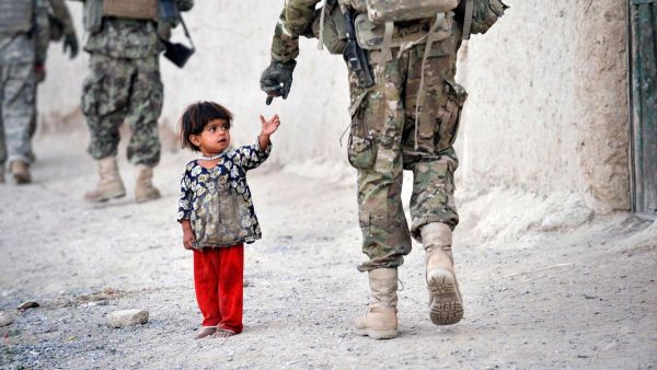 An Afghan girl greets a joint patrol of US troops from the Charlie Company. (AFP/ File)