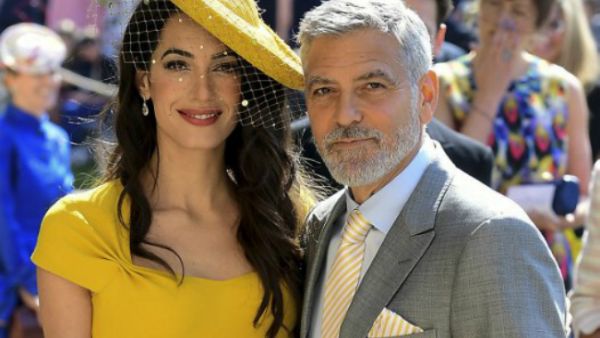 The 57-year-old actor and his wife Amal were invited to watch the former 'Suits' actress tie the knot with Prince Harry (Source: Ian West - POOL - AFP)