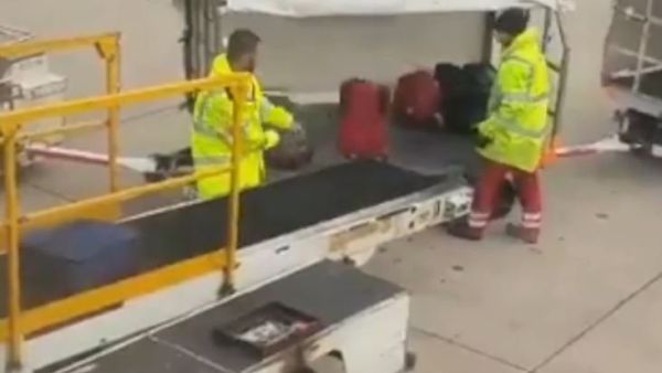A Manchester airport baggage handler's rough treatment of passengers' luggage has been captured on video. (Screenshot)