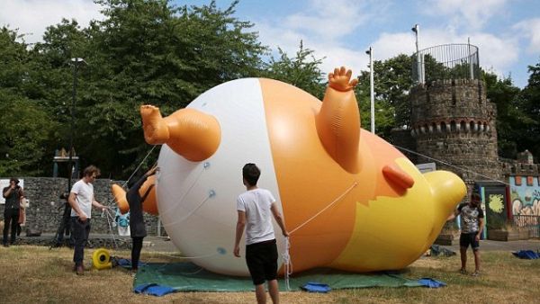 Activists inflate the giant orange balloon in north London ahead of a demonstration set to coincide with Trump's visit  (AFP/File Photo)