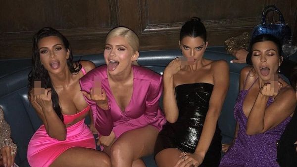 Middle fingers up! 'BIRTHDAY BEHAVIOR! WERE ALL TURNING 21!!' Kylie captioned the group shot of her family (Instagram)