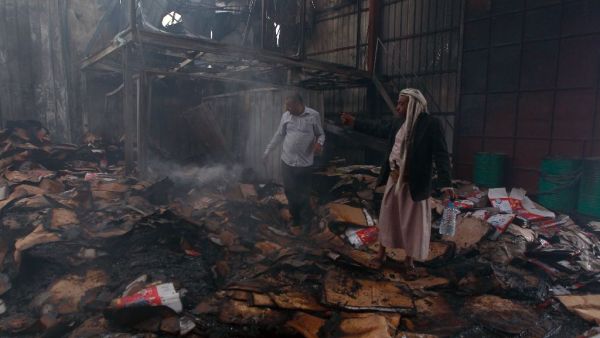 Employees check the damage at a food factory in Yemen's rebel-held capital Sanaa, after it was hit by a Saudi-led coalition strike on August 9, 2016. (AFP/Mohammed Huwais)
