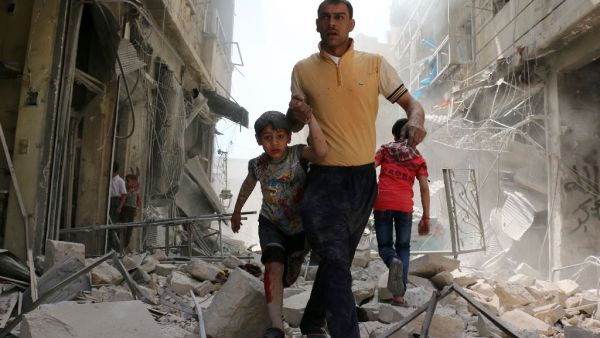 A Syrian man evacuates an area following a reported airstrike on April 22, 2016 in a rebel-held neighbourhood of Aleppo. (AFP/Ameer Alhalbi)
