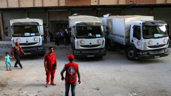 A source said sealed aid trucks coming from Turkey to Aleppo would be opened inside the city by the Syrian Red Crescent, which would distribute the aid. (AFP/Amer Almohibany) 