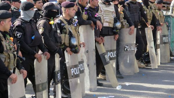 Iraqi security forces stand guard during a demonstration at Baghdad's Tahrir Square in May. (AFP/Jean Marc Mojon)