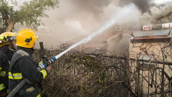 Israeli firefighters help extinguish a fire in the northern Israeli port city of Haifa on November 24, 2016. (AFP/Jack Guez)