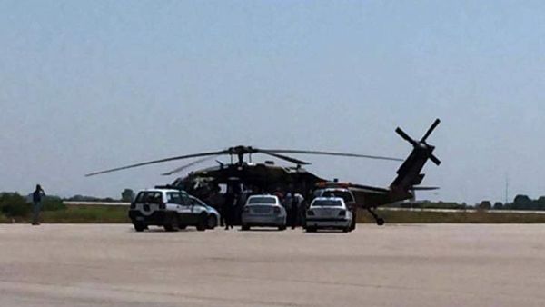Greek police vehicles next to a Turkish military helicopter at Alexandroupolis airport, after it landed there carrying eight officers seeking asylum after a coup bid in Turkey, on July 16, 2016 (AFP/File) 