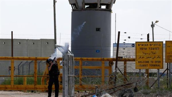 An Israeli soldier fires tear gas canisters towards Palestinian protesters outside the compound of the Israeli-run Ofer prison, in the occupied West Bank. (AFP/File)  