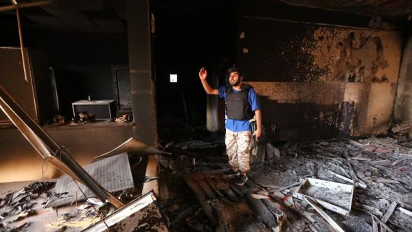 A fighter from the Government of National Unity (GNA) stands in a severely damaged state regulation prison after taking control of the area from the Daesh group in Sirte, east of the capital on August 26, 2016.