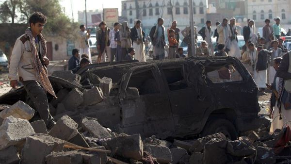 Yemenis stand at the site of a Saudi airstrike against Houthi rebels near Sanaa Airport last year, which killed at least 13 people. (AFP/Mohammed Huwais)