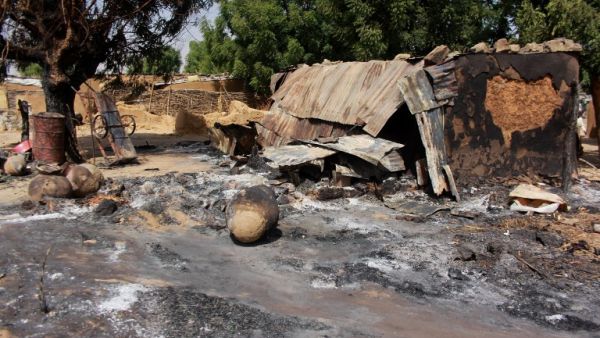 A picture taken on December 17, 2018 shows mud houses burnt down by Boko Haram fighters in the Maiborti village, on the outskirts of Maiduguri, northeast Nigeria. Hundreds fled late on December 16, 2018 after Boko Haram burned their homes near Nigeria's northeastern city of Maiduguri, residents told AFP. Boko Haram fighters in several trucks stormed Maiborti village, five kilometres (miles) outside Maiduguri, firing indiscriminately and setting fire to homes, they said. AUDU MARTE / AFP