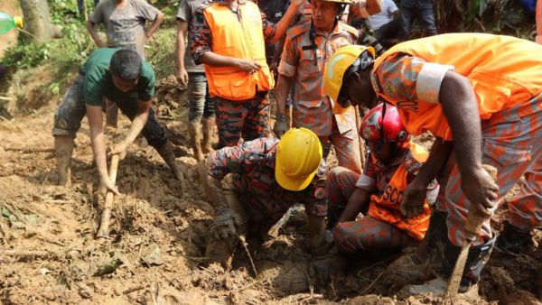 Bangladeshi firefighters try to recover a dead body after a landslide in Rangamati on June 14, 2017.
Rescue workers battled June 14 to reach victims of the worst landslides ever to hit Bangladesh, as the death toll rose to 146, with dozens more still missing. (AFP)
