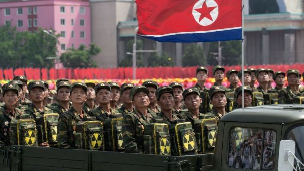 In this photo taken on July 27, 2013, Korean People's Army (KPA) soldiers carrying packs marked with a radioactive symbol take part in a military parade in Pyongyang (Ed Jones/AFP)
