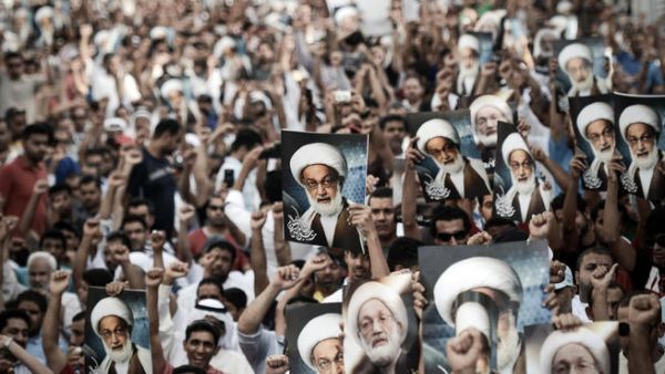 Bahraini protestors shout slogans and hold up pictures of Bahraini top senior shiite cleric, Sheikh Isa Qassim, during an anti-government rally to support Qassim in the village of Diraz, west of the capital Manama, on May 24 (Mohammed Al-Shaikh/ AFP)
