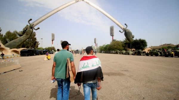 Two Sadrist protesters walk through Baghdad's Green Zone, after a weekend of protests and sit-ins demanding parliamentary change (AFP/Haidar Mohammed Ali)