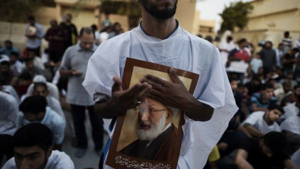 Bahraini protesters hold posters of Sheikh Qassim in June, after Bahraini authorities stripped him of his citizenship. (AFP/File) Bahraini protesters hold posters of Sheikh Qassim in June, after Bahraini authorities stripped him of his citizenship. (AFP/File)