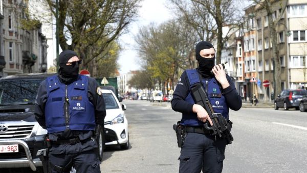 Belgian police stand guard near a warehouse connected to the militants in Etterbeek, Belgium. (AFP/Thierry Charlier)