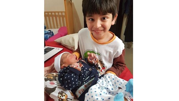 Big brother Saad and baby Fahad, five years apart, are pictured together at home. Their mother says she understands why some women struggle with breastfeeding.