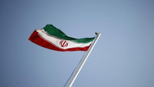 An Iranian flag flutters outside an annual oil and gas conference in Tehran. (Reuters)