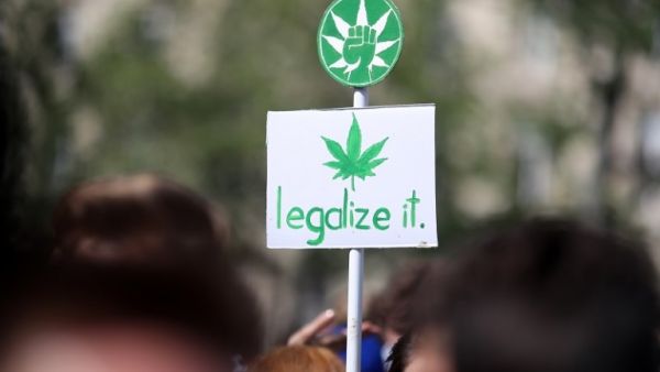 A banner picturing a cannabis leaf and reading “legalize it” during a march for cannabis and marijuana in Paris. (AFP/ File)