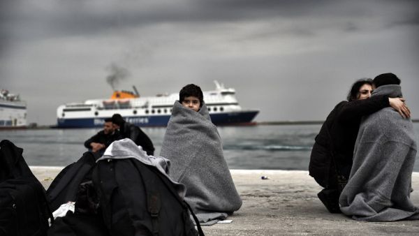 A Syrian child wrapped in a blanket waits on the shore of Lesbos, Greece. (AFP/Aris Messinis)
