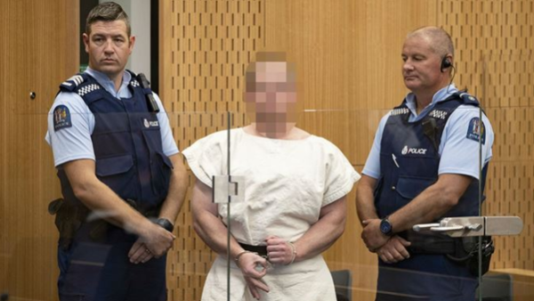 Accused Christchurch massacre gunman Brenton Harrison Tarrant (pictured) has made a white power gesture from behind a glass window, during a brief appearance in court (Twitter)