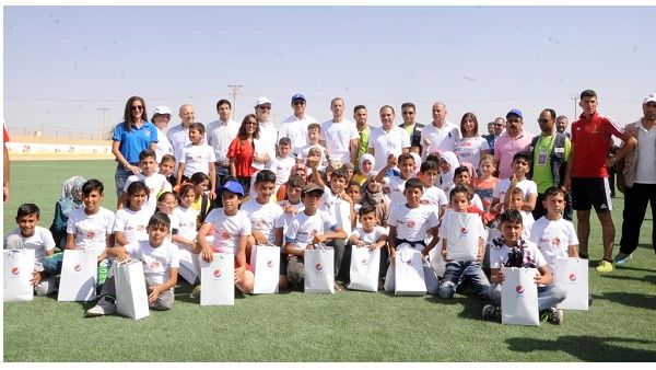 Prince Ali Bin Al Hussein surrounded by more than 200 girls and boys living in the camp during the opening ceremony on Tuesday September 12, 2017. 
