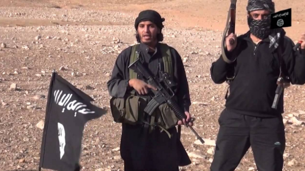 Daesh militants with weapons and flags. (Screenshot)