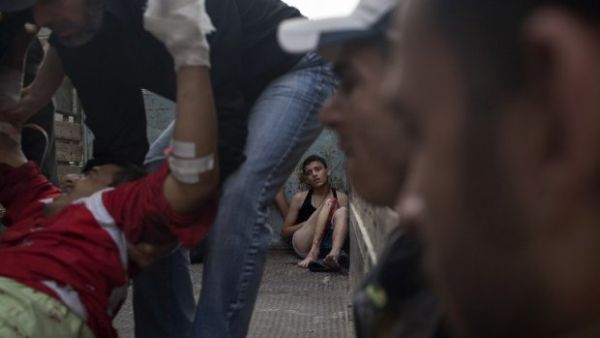 A young Syrian injured in an attack by regime forces waits to be taken to hospital, October 21, 2012, in Aleppo. (AFP/Fabio Bucciarelli)