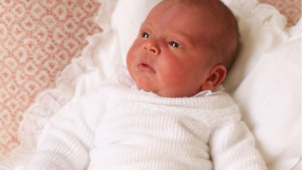 Louis appears wide awake in a white outfit as he gazes at something out of shot of the camera (Source: Kensington Palace - Twitter)