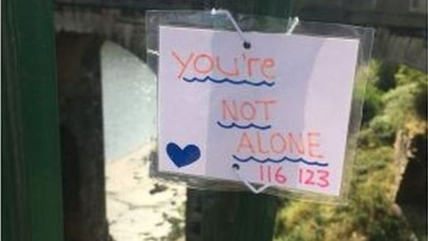 Police say a teenager who attached uplifting messages to a bridge to help people facing a mental health crisis has helped save six lives (Twitter)
