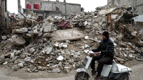 Mute 17-year-old Syrian Adnan, who lost both legs in 2014 following an airstrike as he was walking towards his father's store from school, rides a motorcycle in the rebel-held town of Douma, on the outskirts of the capital Damascus, on February 16, 2017. [AFP/Sameer Al-Doumy]